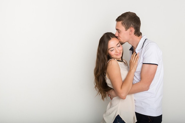 Young couple hugging and kissing. Happy man and woman in love together, copy space