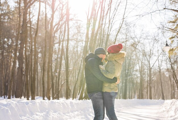 Young couple hugging and kissing in the Park in winter.