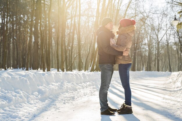 Young couple hugging and kissing in the Park in winter.