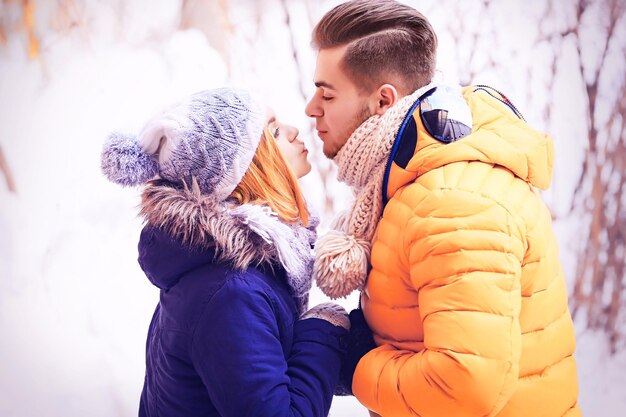 Young couple kissing outdoors in winter