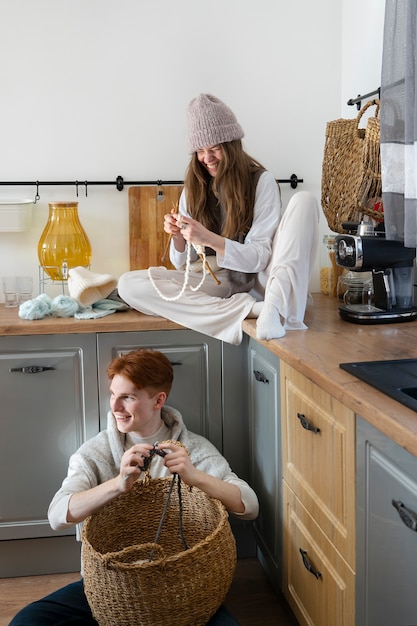 Young couple knitting together