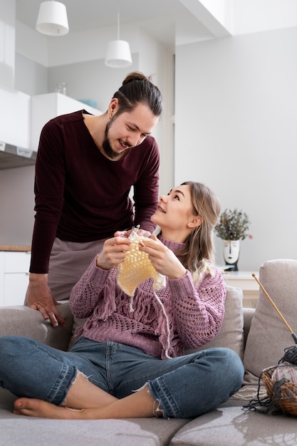 Young couple knitting together