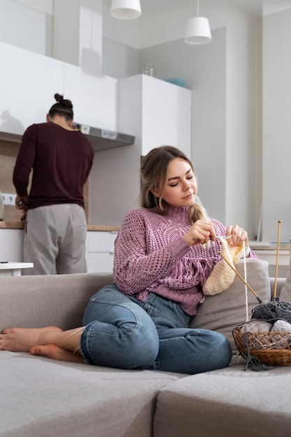 Young couple knitting together