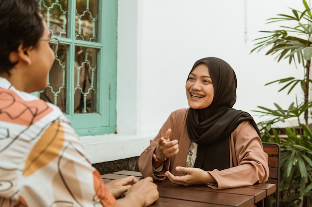 Young couple laughing while chatting face to face