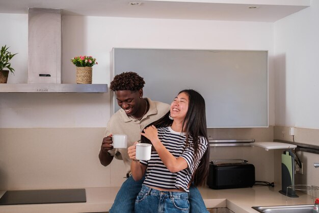 Young couple laughing while chatting having breakfast together in the kitchen Concept lifestyle couple fun