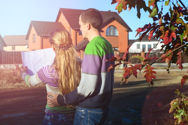 Young Couple Look At Home Plans