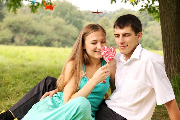 Young couple looking at the big candy