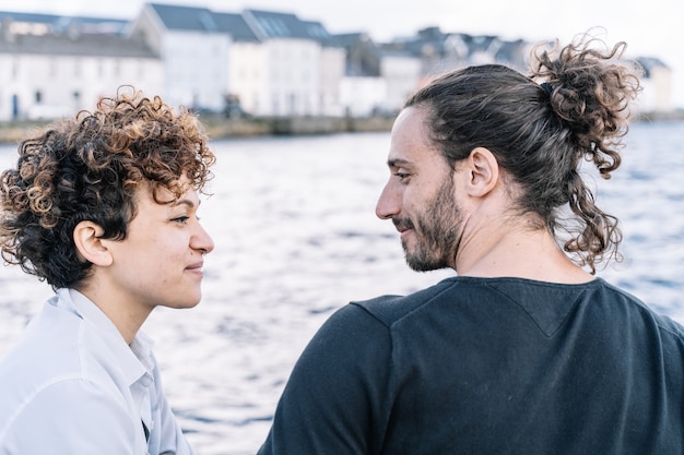 Young couple looking at each other with the  sea out of focus