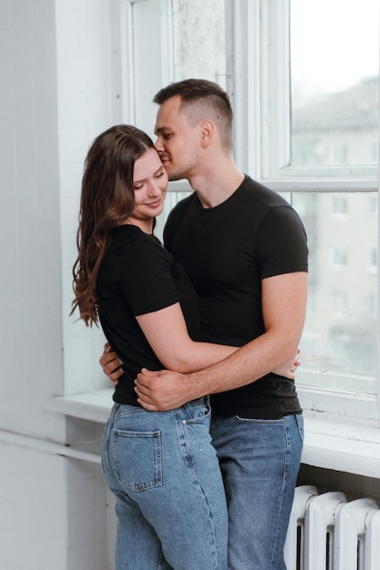 A young couple in love in black Tshirts