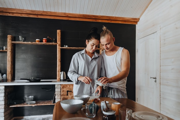 Young couple in love cook healthy food in the kitchen together