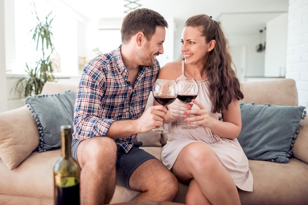 Young couple in love drink red wine