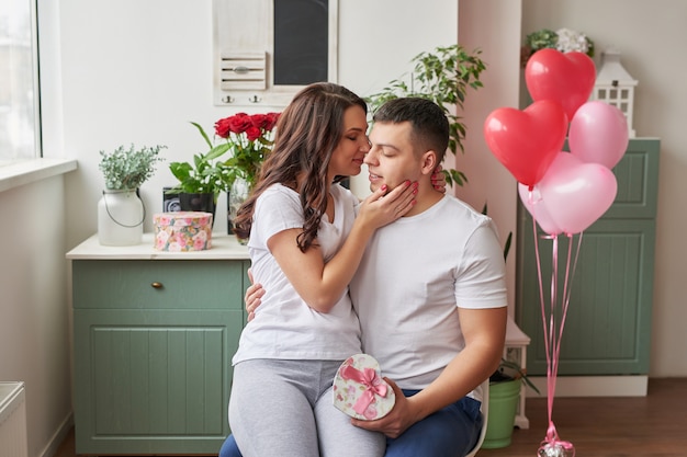 Young couple in love at home celebrating Valentine's Day