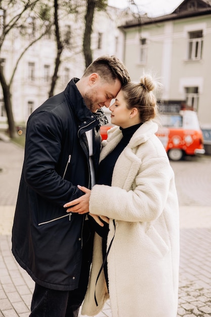 A young couple in love is walking on the street and enjoying the fresh air Happy married couple A stylish couple a man and a woman