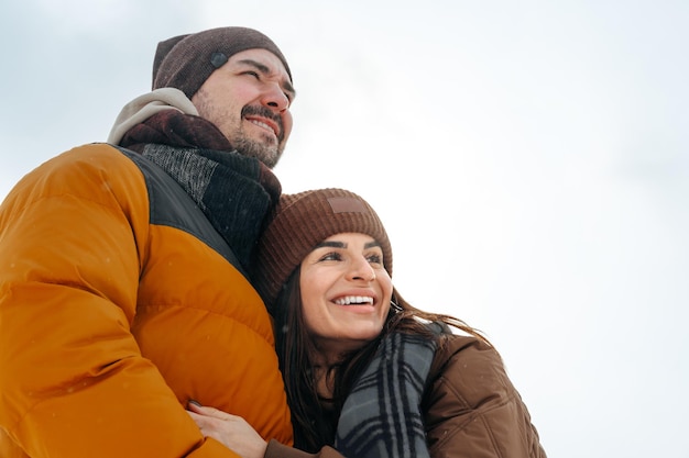 Young couple in love outdoor in snowy winter forest