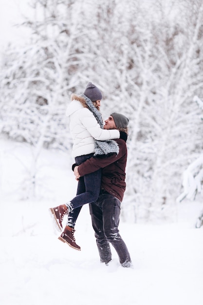 Young couple in love outdoor snowy winter