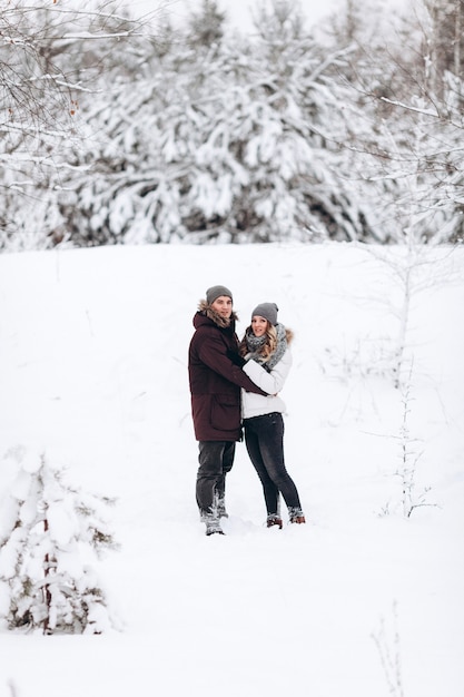 Young couple in love outdoor snowy winter