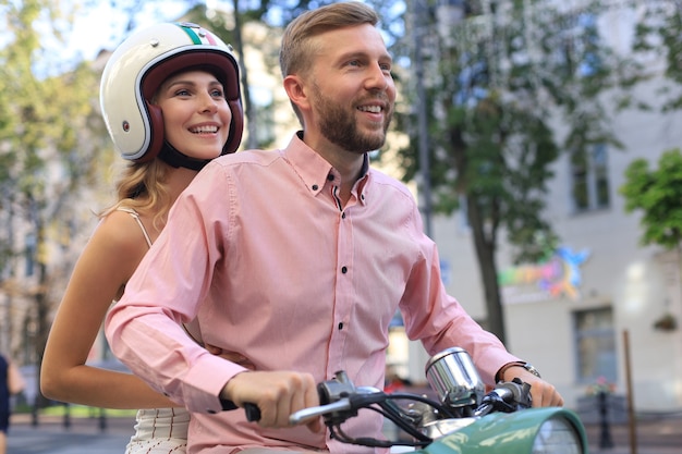 Young couple in love riding a motorbike. Riders enjoying themselves on trip. Adventure and vacations concept.