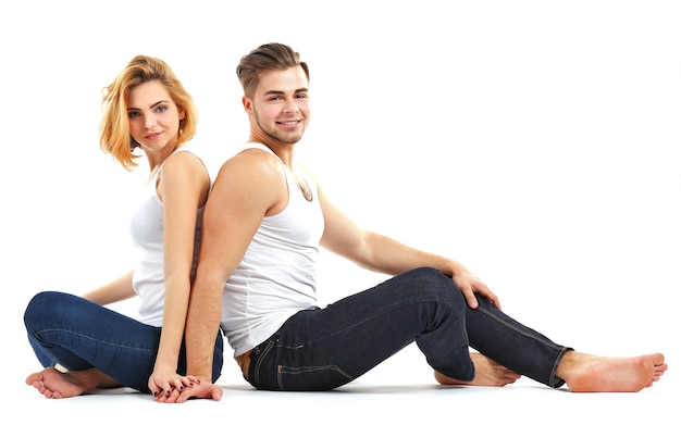 Young couple in love sitting together isolated on white