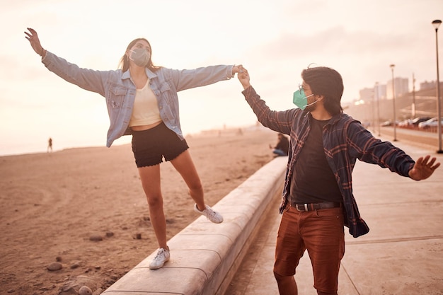 Young couple in love walk along the beach during a beautiful sunset