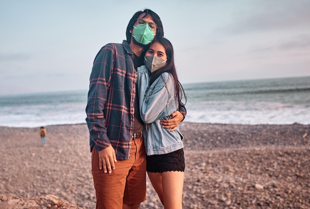 Young couple in love walk along the beach during a beautiful sunset