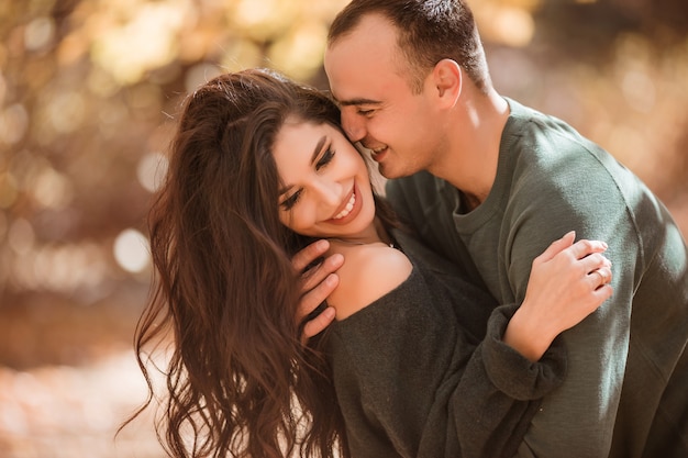 young couple in love walking in the autumn forest