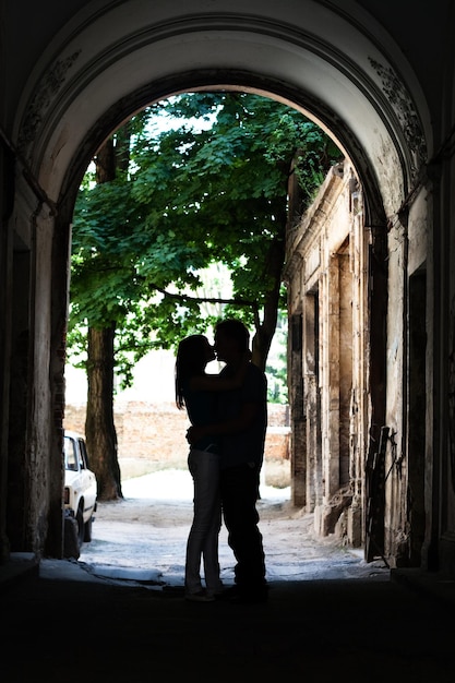 A young couple in love walks the streets of an ancient European city