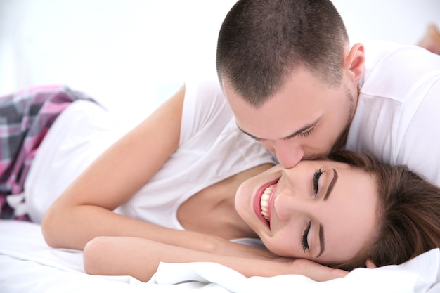 Young couple lying together in bed