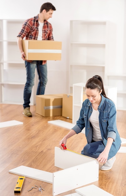 Young couple moving in new home house.