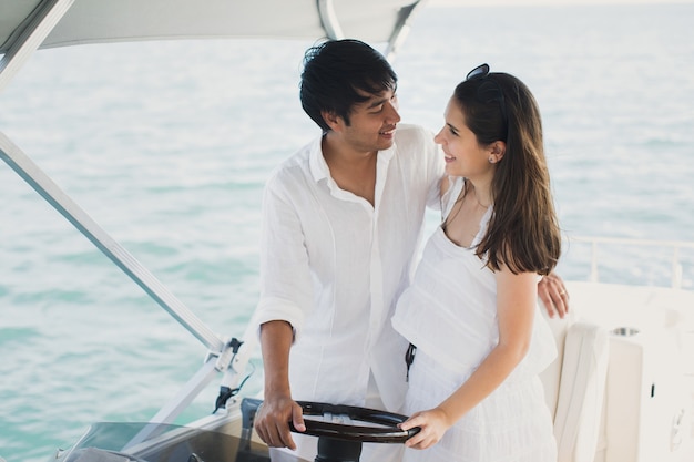 Young couple navigating on a yacht in Indian ocean