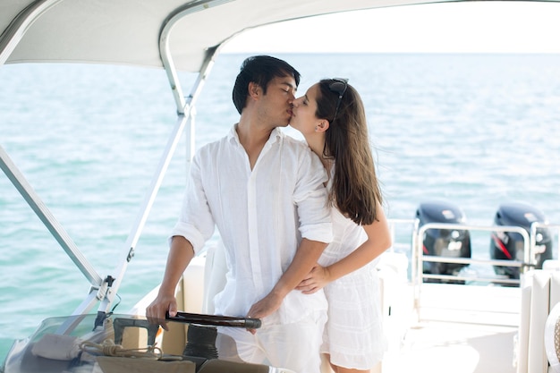 Young couple navigating on a yacht in Indian ocean