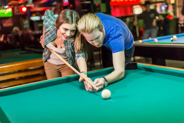 Young couple playing pool