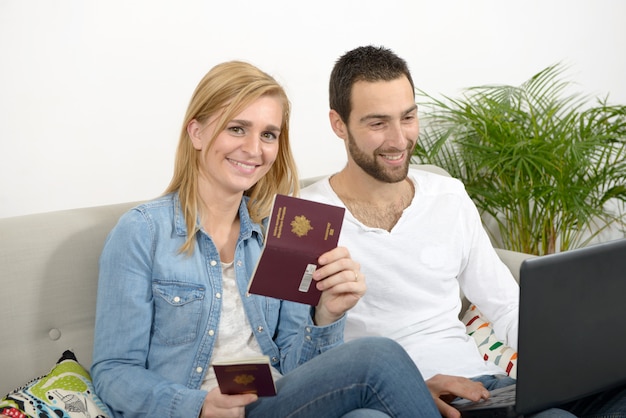 Young couple preparing vacation trip with passport