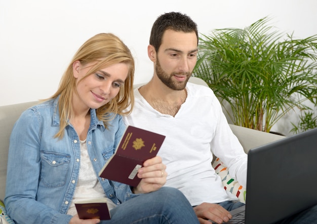 Young couple preparing vacation trip with passport