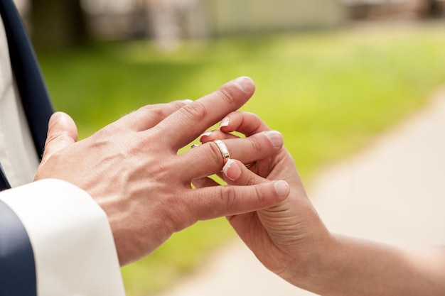 Young couple puts very romantic wedding ringsEngagement ring