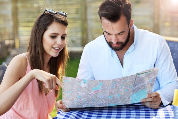 A young couple reading map in cafe