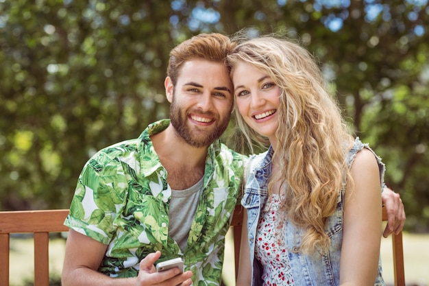 Young couple relaxing on park bench 