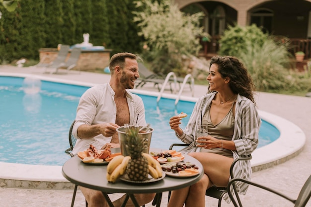 Young couple sitting in the backyard