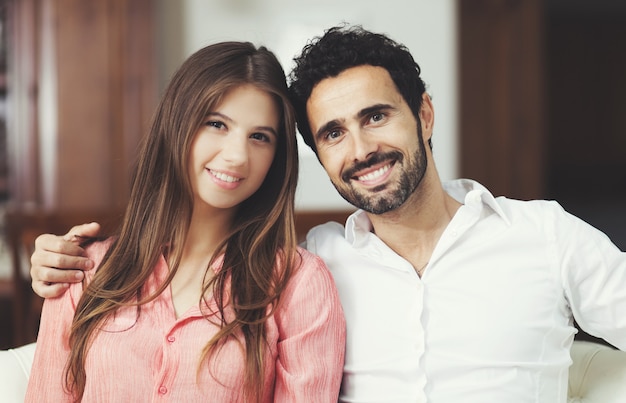 Young couple on the sofa in love