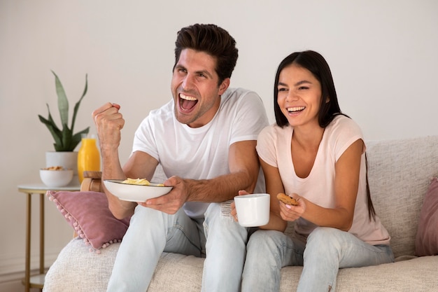 Young couple spending time in front of tv