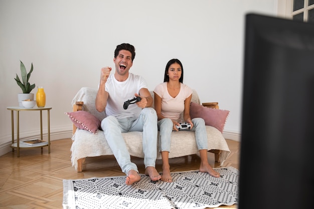 Young couple spending time in front of tv