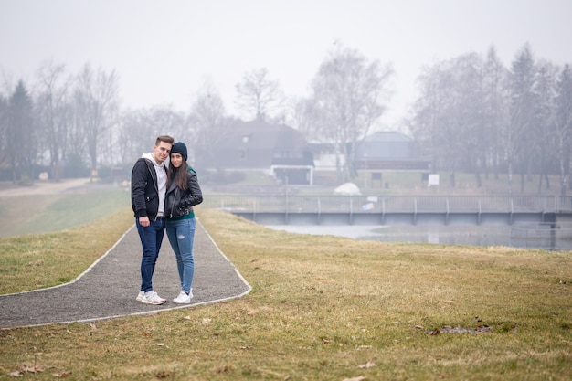 Young couple spending time together at Lake Gebart on a foggy winter day in Zalaegerszeg, Hungary