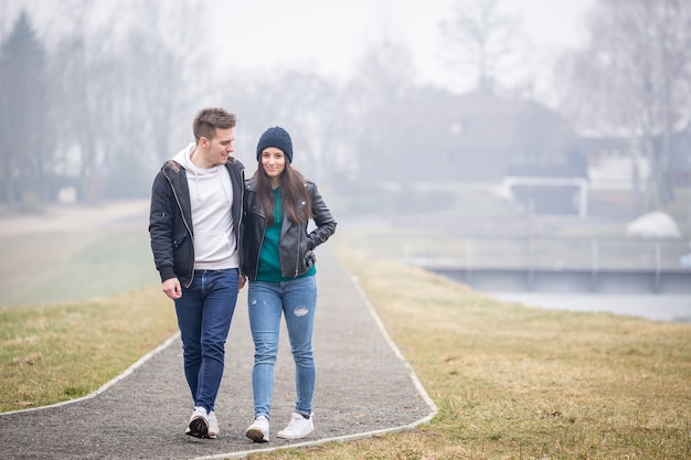 Young couple spending time together at Lake Gebart on a foggy winter day in Zalaegerszeg, Hungary