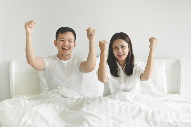 Young couple sport fans cheering team victory while watching football match on tv at home.