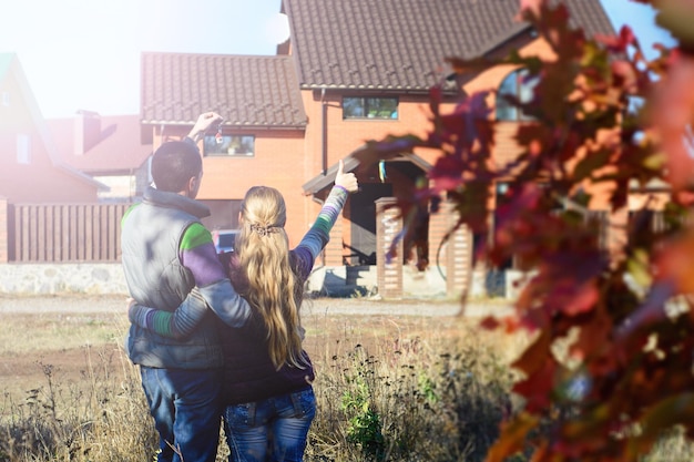 Young Couple Standing Outside Dream Home