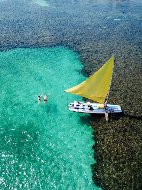 Young couple swimming in the natural pools in Porto de Galinhas Pernambuco - Brazil