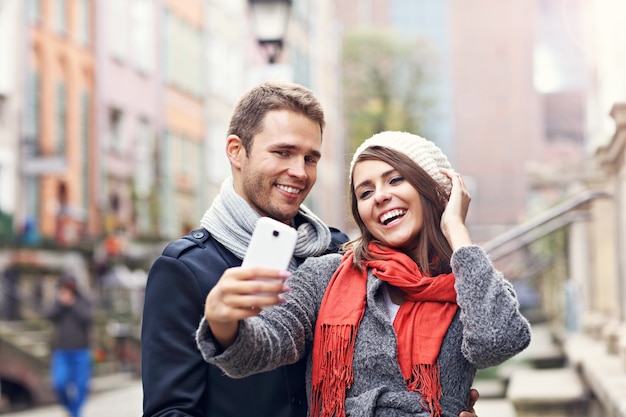 young couple taking selfie in the city