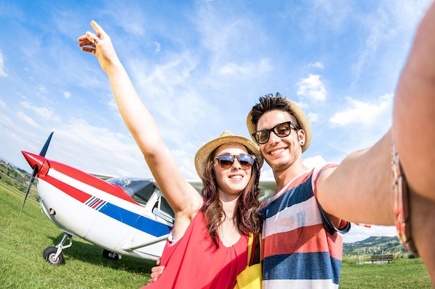 Young couple taking selfie with lightweight airplane