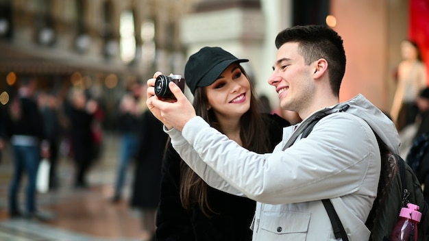 Young couple of turists taking pictures in the city