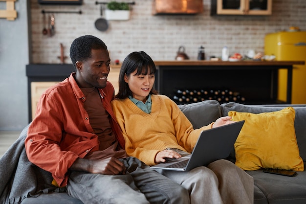 Young Couple using Laptop on Couch