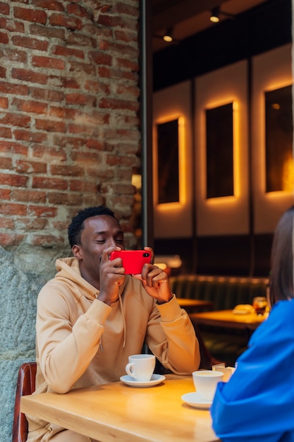 Young couple using mobile device in a coffee shop